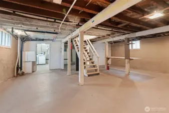 Large unfinished basement with tall ceilings and exterior exit