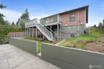 Deck leads to backyard and parking