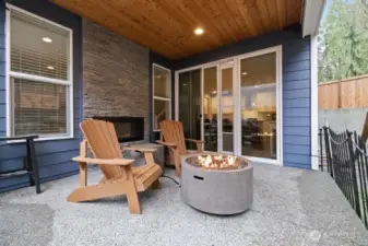 Covered patio with indoor/outdoor gas fireplace, mounted heaters, plumbed for gas grill