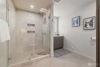 Updated primary bathroom featuring a stunning shower and a backlit mirror.