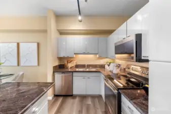 The kitchen, conveniently located next to the dining area, provides ample storage and features stainless steel appliances.