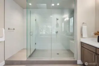 Huge oversized shower with floor to ceiling glass doors. You can enjoy the views of your private backyard from this spa like shower.