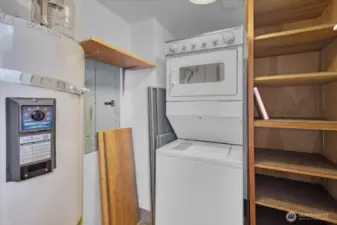 The laundry room has plenty of storage and a brand new hot water tank. There is also a large storage locker in the building next door.