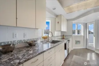 No shortage of light in the kitchen. There is a door onto the patio from here as well as through the living room.