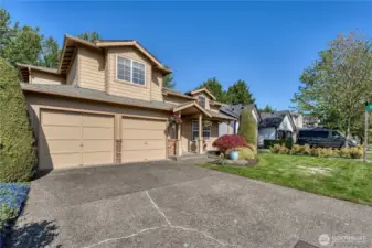 Two car garage with additional room on driveway for parking.