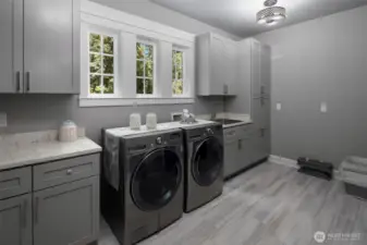 Main floor laundry with plenty of cabinet space.