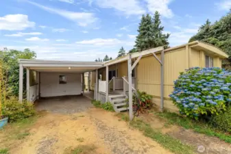carport with 2 storage sheds.