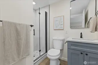 Stunning surround and granite counters in this primary bath.