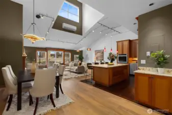 Dramatic open-concept living with soaring ceilings, skylights, and warm wood floors—designed for both everyday living and elevated entertaining.