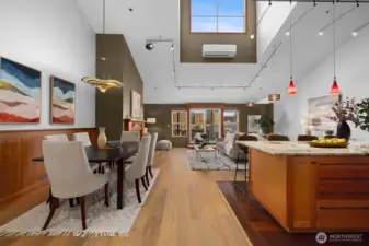 Light-filled great room showcasing vaulted ceilings, skylights, and effortless indoor-outdoor connection.