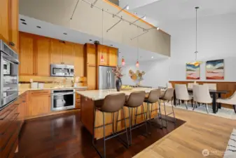 Open sightlines from kitchen to dining create a cohesive, modern living experience with architectural impact.