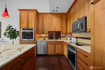 Well-appointed kitchen workspace featuring abundant cabinetry, stainless appliances, and timeless finishes.