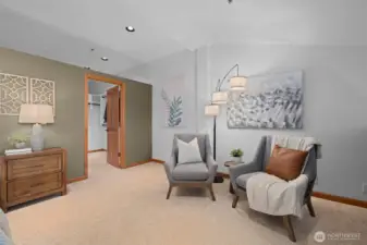 Bonus space in the primary bedroom showcasing plush carpeting and a peaceful, private atmosphere.