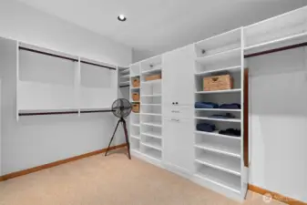 Custom walk-in closet with built-in shelving and hanging space, designed for easy organization and everyday efficiency.