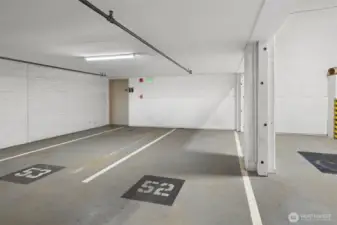 Secure parking garage with clearly marked stalls, offering convenience and peace of mind in the city. Stalls #52 and #69 are assigned to the unit.