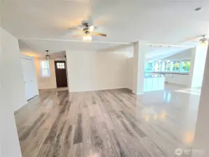 Front living room has open concept to dining and kitchen