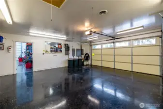 One of two garages, epoxy floors and two 220 amp panels.  Storage is abundant in this garage.