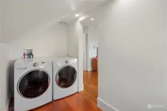 Upstairs laundry room with room for folding table and storage space