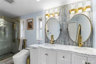 Remodeled hallway bath upstairs featuring spa shower, double vanities and towel warmer