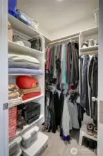 Awesome walk-in closet with built in shelving.