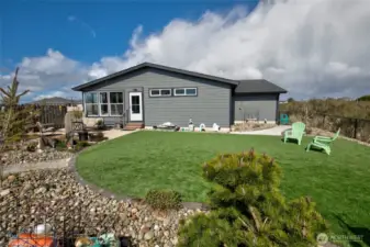 With low maintenance, beach landscaping and astro turf, this yard is both people and puppy friendly!