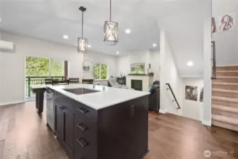 A sliding glass door leads to a private balcony overlooking a lush greenbelt, offering a sense of tranquility and connection to nature.