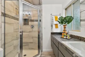 Updated ensuite bath with stylish finishes and cozy heated tile floors.