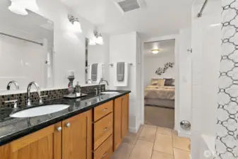 Chic shared bath with modern updates and heated tile floors.
