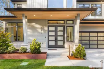 Large covered entry patio with cedar ceiling detail and French Entry Doors