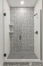 Stunning tile details in this designer mudset shower with frameless glass enclosure.