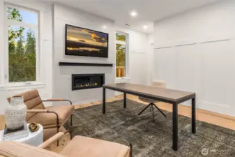 Dedicated Home Office off Entry highlighted by contemporary fireplace with custom floor to ceiling tile surround and custom formal wall panel details. Room also features large walk in closet and accesses main floor 3/4 bath and could be utilized as main floor guest suite