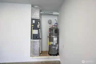 Garage area with heating unit and hot water tank