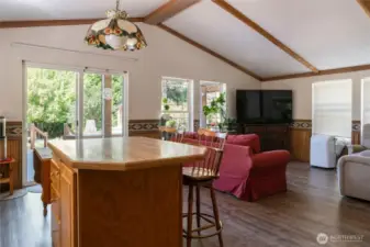 View from fridge. Laundry room and walk-in pantry behind. Wood stove and front door to right.