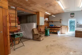 Upper garage / workshop. Bowling lane work benches. So much storage! 1/2 bath and woodstove.