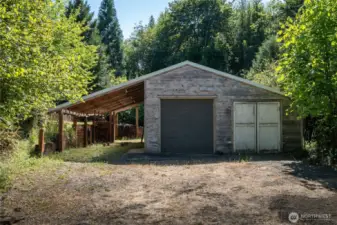 Lower "tractor barn" shop. Large carport. Automatic garage door.