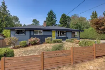 Partially fenced front yard with Japanese Maples and perennials