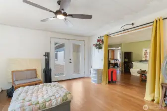 bonus room with ceiling fan and french doors to exterior of home.