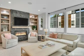 Numerous custom built ins and recessed dimmable lighting flank your rock-faced fireplace.