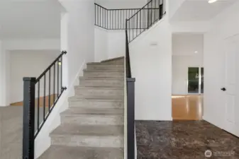 You'll be greeted by an impressive spacious entry with soaring 10 ft ceilings and a wrapping staircase with a custom iron railing.