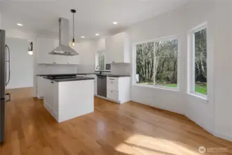 Open airy kitchen with eating area.