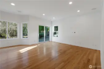 Open family room off the kitchen has richly refurbished hardwood floors, recessed lighting, and speaker system perfect for movie night!  Sliding doors lead to your private backyard with patio for BBQs.