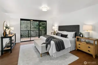 Primary bedroom on the main level also has deck access.