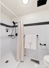 Walk-in shower and toilet off the dressing area.