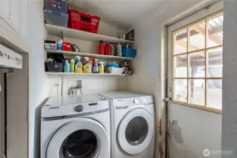 Utility room with access to porch and backyard. W/D convey with salesre.