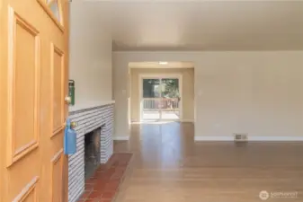 Upstairs entry to formal living room, with warm wood burning fireplace
