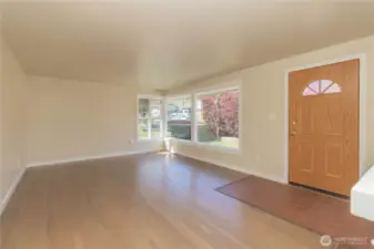 Another view of large picture windows in formal living room