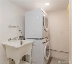 Full size stacked front loading washer and dryer with utility sink