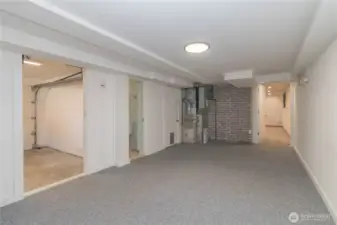 Another view of flex space with wet bar/mini kitchen area through door on right