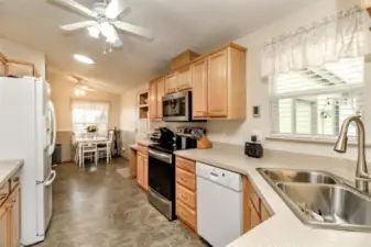 Kitchen leads to informal dining area that faces over the front porch and street.