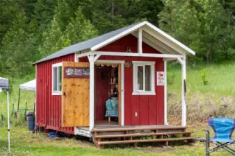 A delightful tiny home is well-appointed with a kitchen, 1/2 bath and room to sleep.